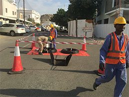 Fibre crew working at the roadside behind cones